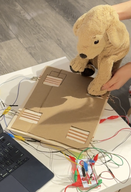 The dog interacts naturally with the layout, confirming that the spacing works for intuitive movement. However, we still need to test whether dogs of different sizes will trigger the pads accurately.