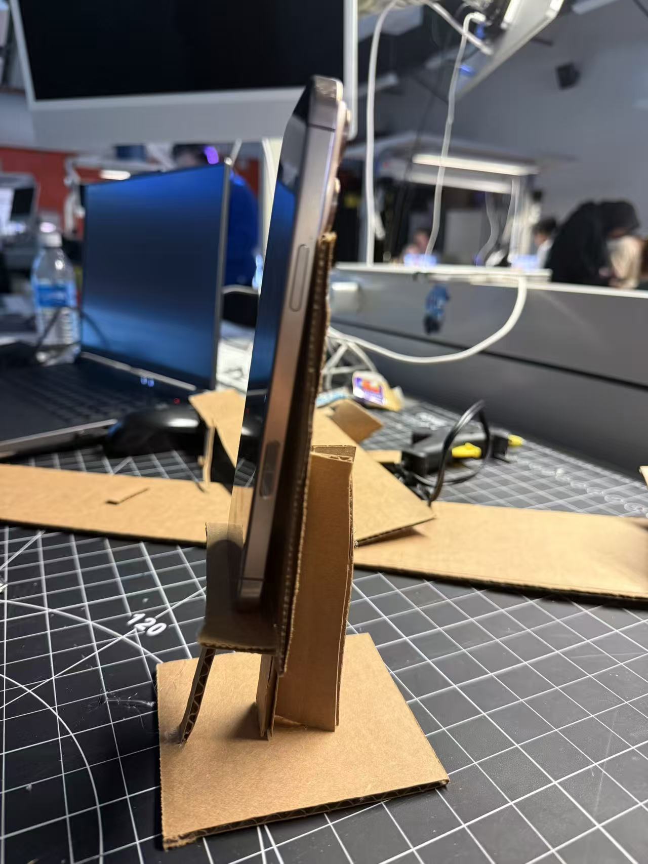 I reinforced the vertical build and tested how much weight the cardboard could handle, analyzing whether the thin structure could maintain strength without collapsing.