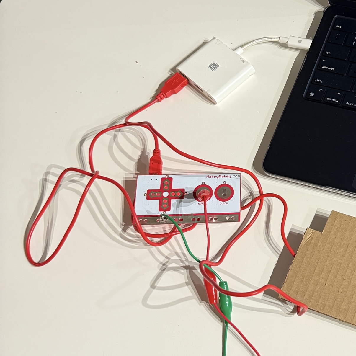 I connected the MakeyMakey to my laptop and attached alligator clips to the input and ground ports to prepare for testing the physical button.
