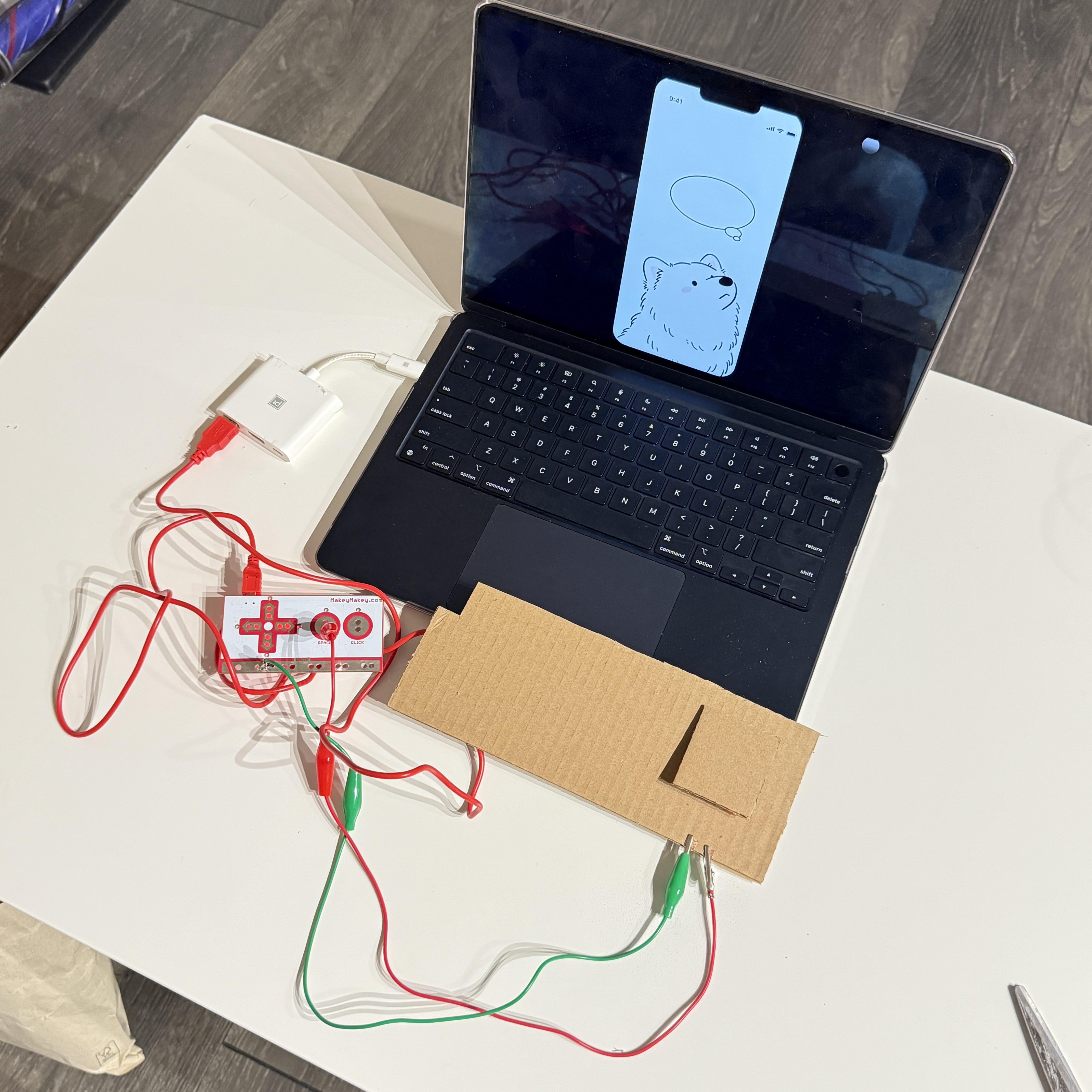 I tested the full setup by pressing the cardboard button, which sent a signal to ProtoPie and triggered my interaction on the laptop screen.